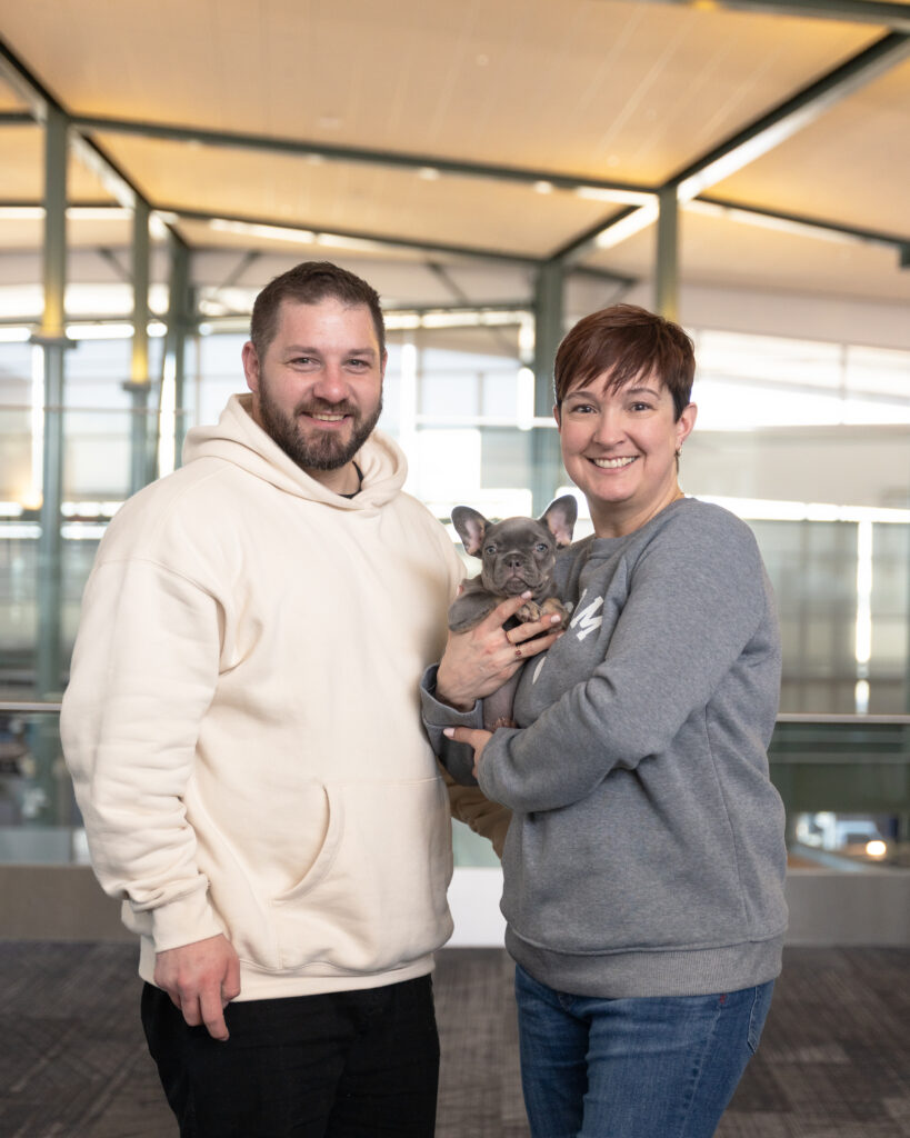 Happy family with their healthy French Bulldog puppy from a reputable breeder
